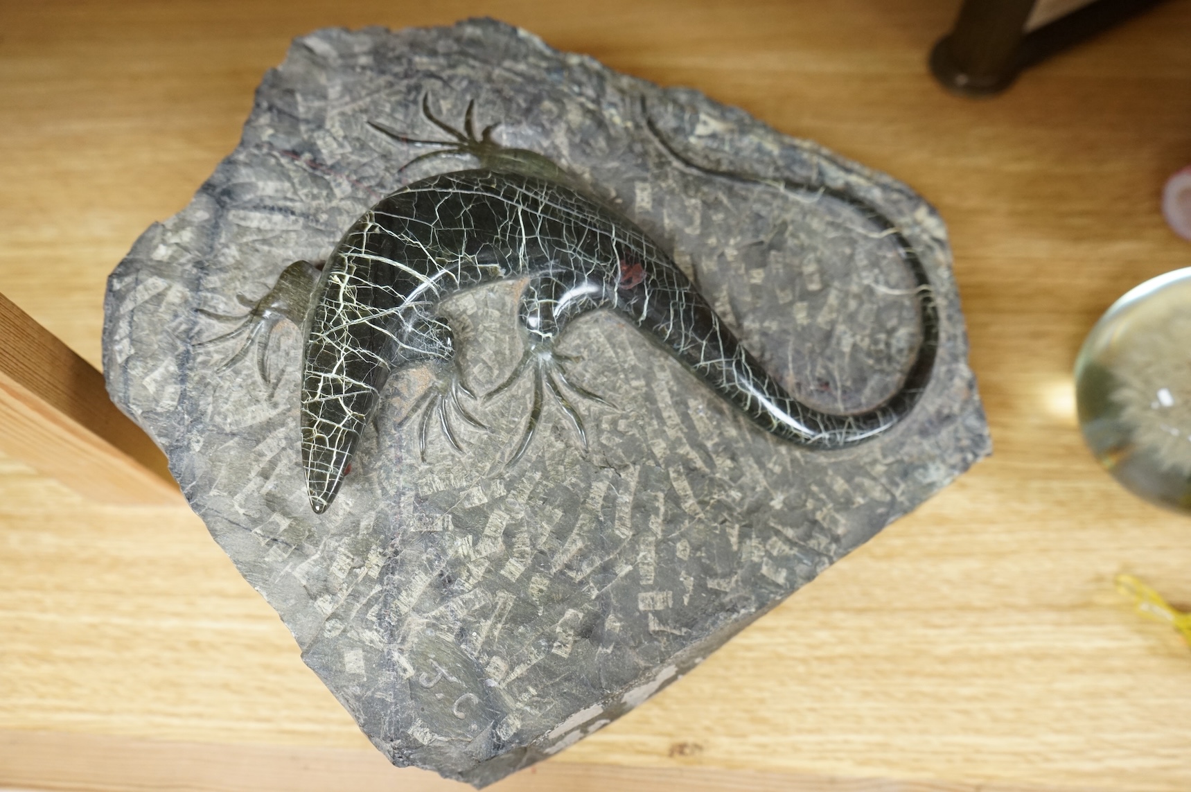 A carved green granite lizard, 27cm wide